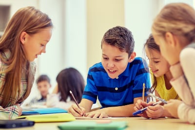 Students working together at a common table.