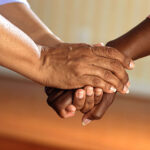 A photo of two people clasping hands